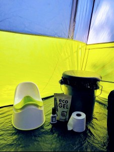 potty and luggable loo in tent shows set up for camping with kids